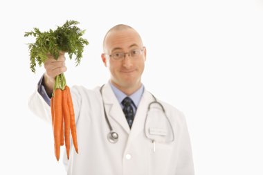 Doctor holding carrots. clipart