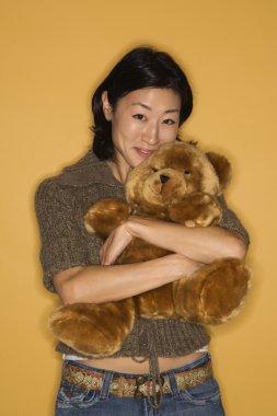 Woman holding teddy bear. clipart