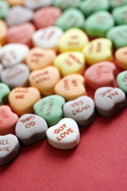 Candy hearts on red. clipart