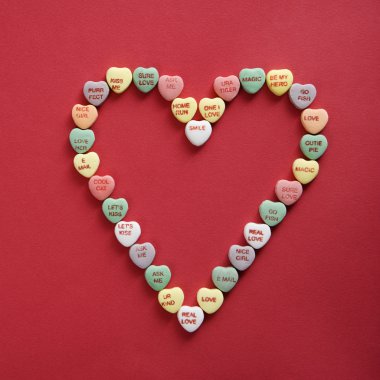 Candy hearts on red. clipart