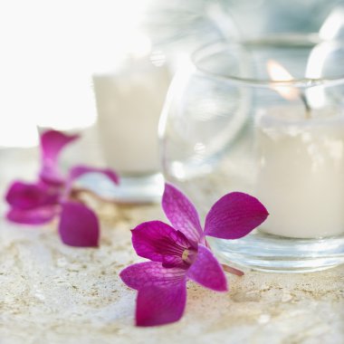 Lit candles and orchids. clipart