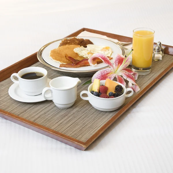 Breakfast tray on white bed. — Stock Photo, Image