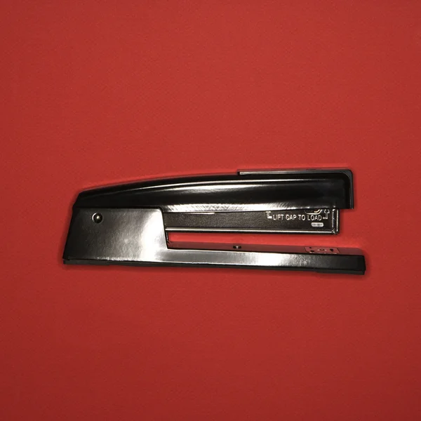 Stapler on red. — Stock Photo, Image