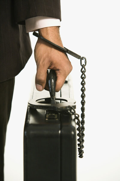 Businessman locked to briefcase.