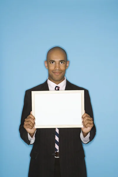 Businessman holding blank sign. — Stock Photo, Image