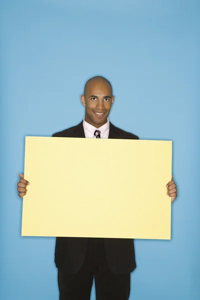 Businessman holding blank sign. — Stock Photo, Image