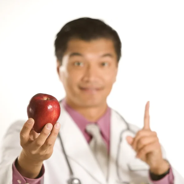 Doctor holding apple. — Stock Photo, Image