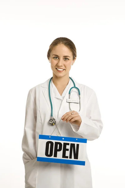 Lekarz posiadający otwarty znak. — Zdjęcie stockowe