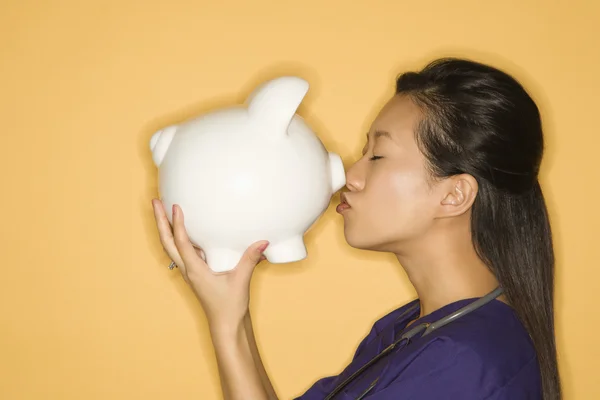 Woman kissing piggy bank. — Stock Photo, Image