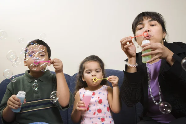Family blowing bubbles. — Stock Photo, Image