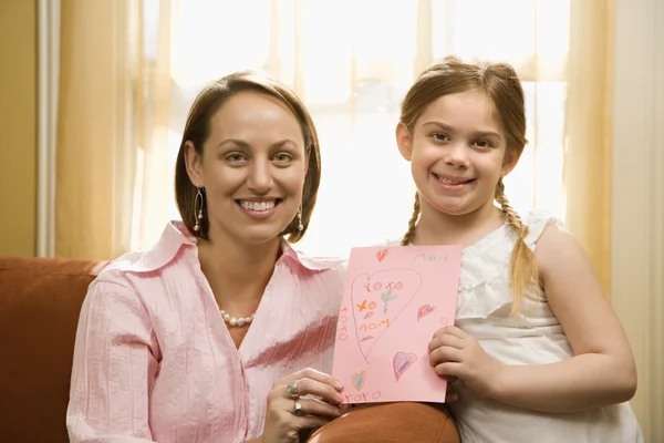 Girl giving mom drawing. — Stock Photo, Image