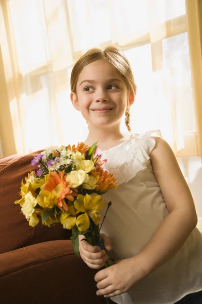 Girl holding flowers. — Stock Photo, Image