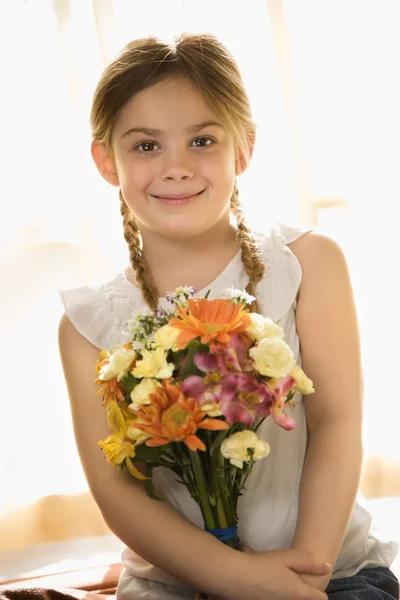 Girl holding flowers. — Stock Photo, Image