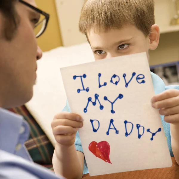 Boy giving dad drawing. — Stock Photo, Image