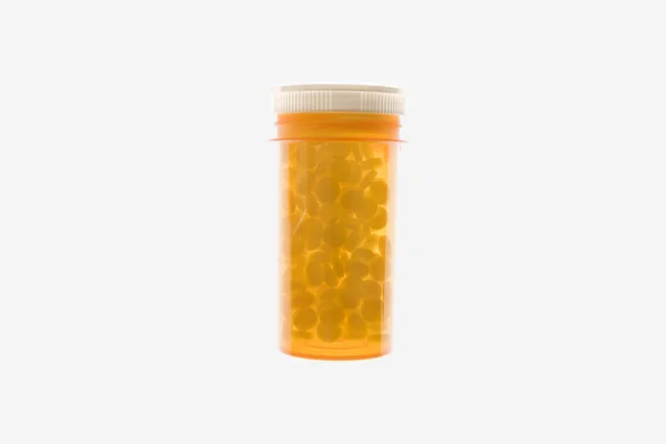 Žlutá plastová lék láhev. samostatný — Stock fotografie