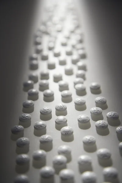 Lined Up White Pills — Stock Photo, Image