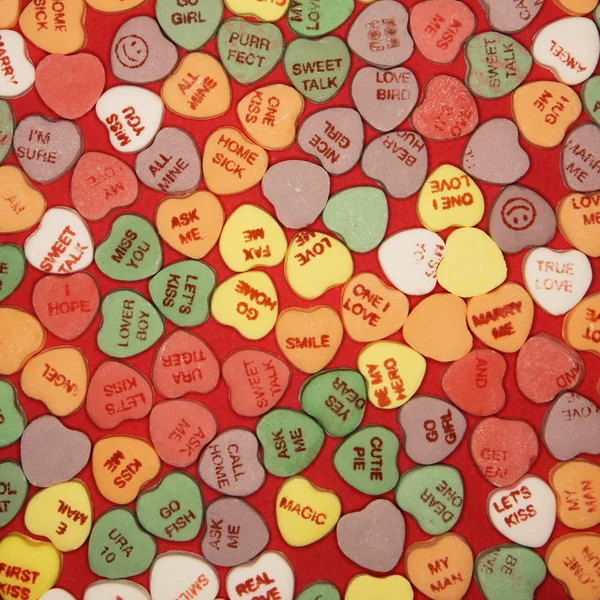 Candy hearts on red. — Stock Photo, Image