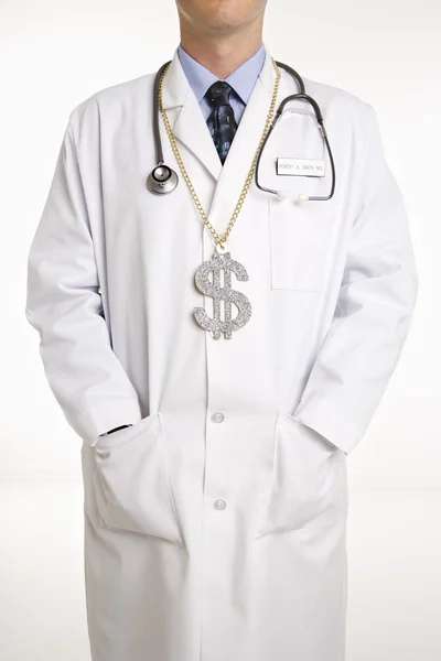 Γιατρός που φοράει το σύμβολο του δολαρίου. Royalty Free Εικόνες Αρχείου