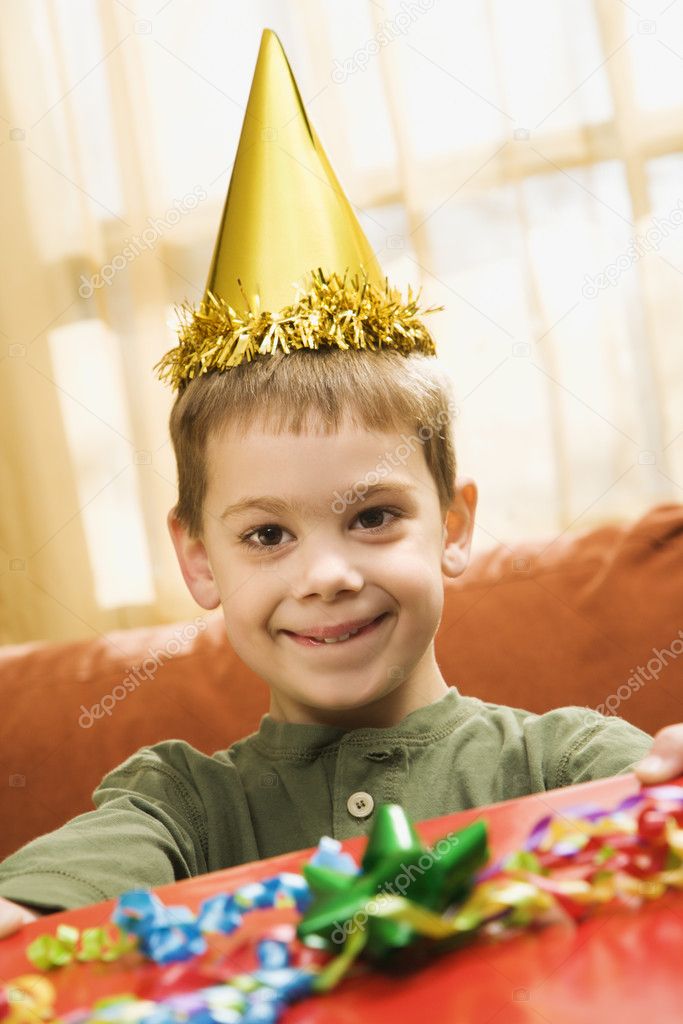 Boy holding birthday gift.