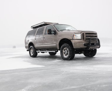 Truck on frozen lake. clipart