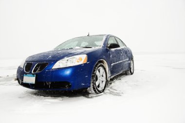 Sedan Parked on Ice sheet. clipart