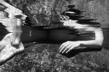 Nude woman underwater. clipart