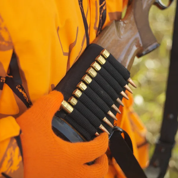 Hunter removing bullet from ammo holder. — Stock Photo, Image