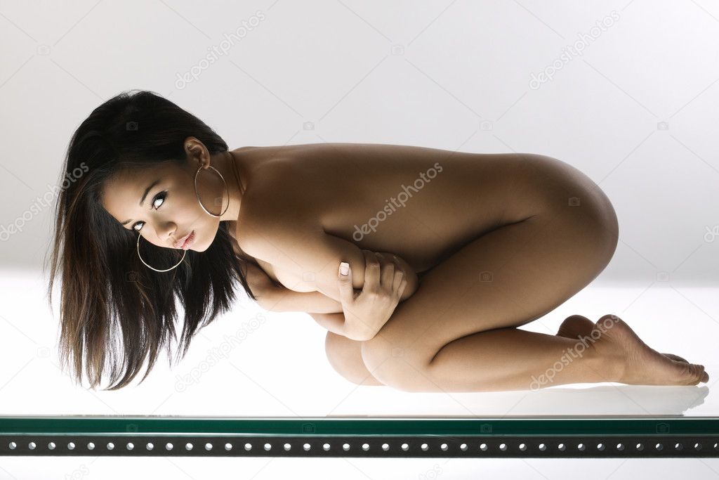 Nude woman kneeling.