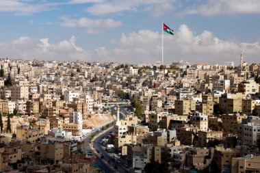 View of the city of Amman with Jordanian flags clipart