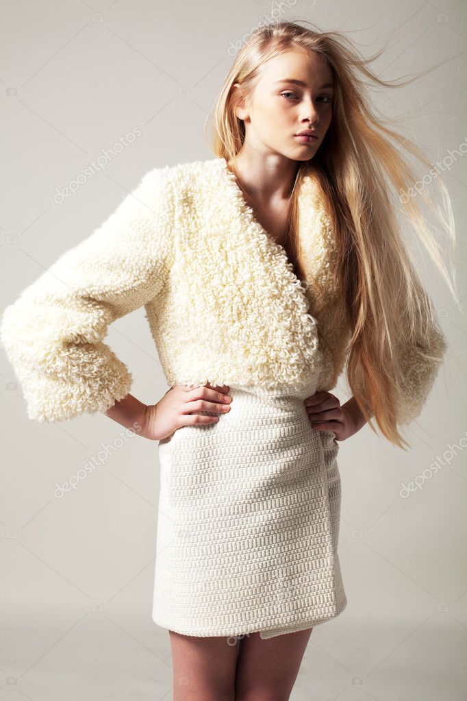 Blond woman in fashion coat with long hair