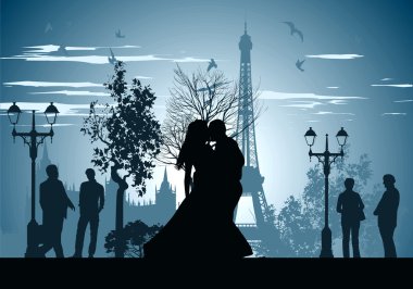 Man and woman kissing on a street in Paris clipart