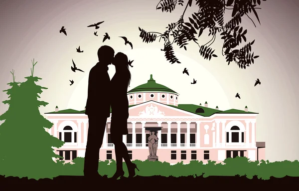 Couple kissing near the old house in the middle of the park — Stock Photo, Image