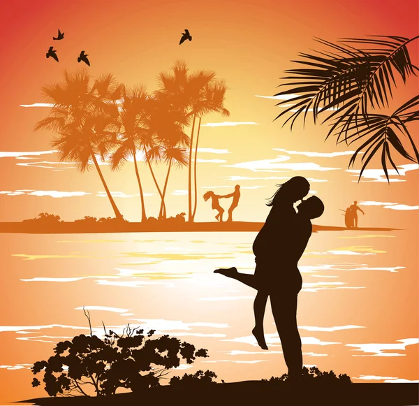 Man embraces woman on the shore of the beach at sunset — Stock Photo, Image