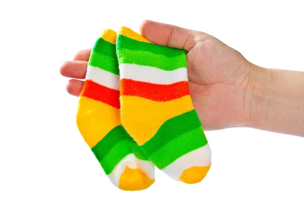 Two baby socks in woman 's hand . — стоковое фото