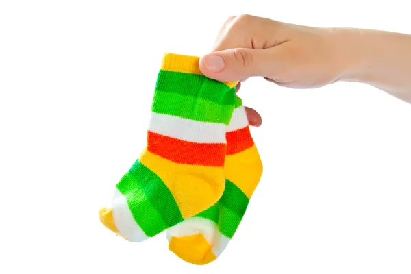 Two baby socks in woman 's hand . — стоковое фото