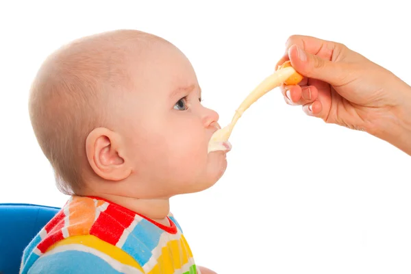 Little baby is feeding curds from spoon Royalty Free Stock Images