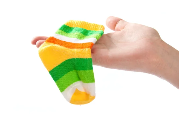 Un calcetín de bebé en la mano de mujer . —  Fotos de Stock
