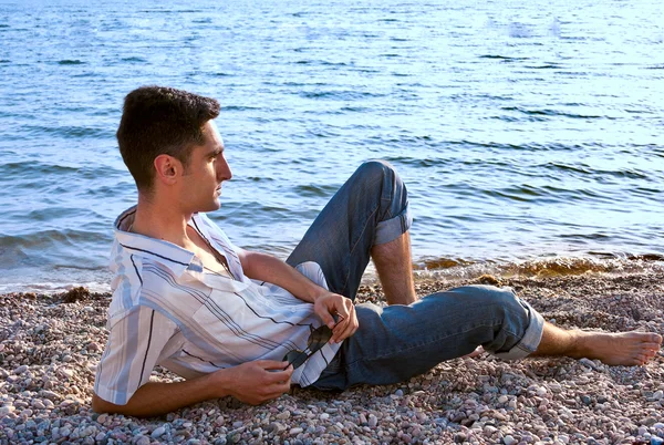 stock image Young man on the sea coast.