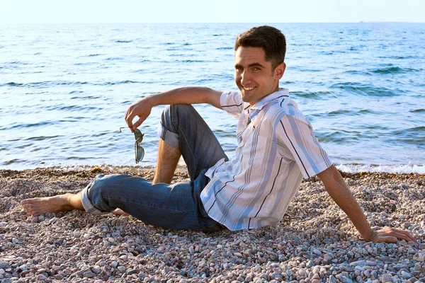stock image Young man on the sea coast.
