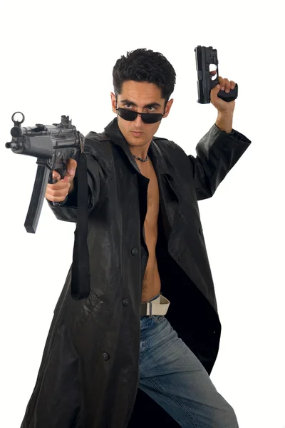 Handsome man with gun in leather raincoat — Stock Photo, Image