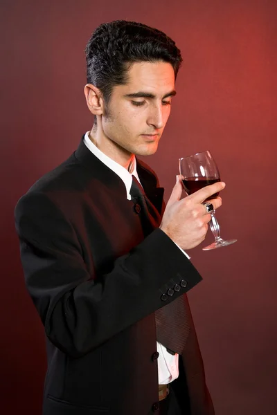 stock image Glamour man with bocal of red wine.