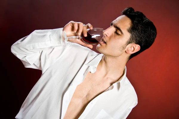 Glamour man with bocal of red wine. — Stock Photo, Image