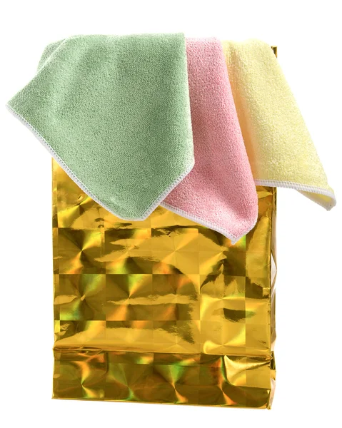Gold paper-bag and towels. — Stock Photo, Image