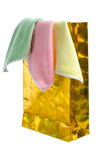 Gold paper-bag and towels. — Stock Photo, Image