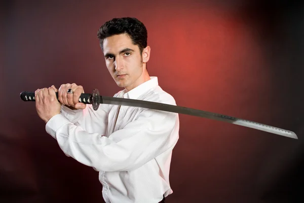 Handsome man with sword. — Stock Photo, Image
