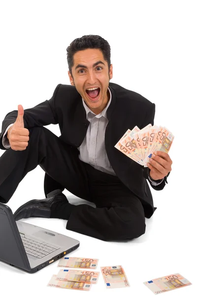 Successful businessman working on laptop and euro — Stock Photo, Image