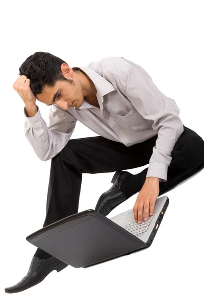 stock image Pensive man working on laptop