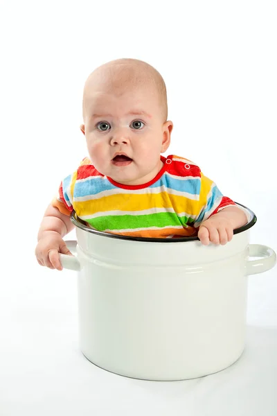 Baby sitting in the big saucepan. — Stock Photo, Image