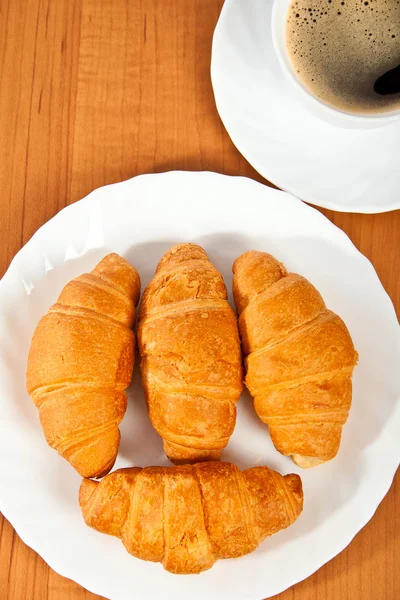 Newly-baked croissants and cup of coffee. — Stock Photo, Image