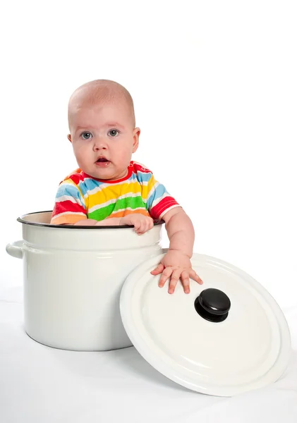 Baby sitting in the big saucepan. — Stock Photo, Image